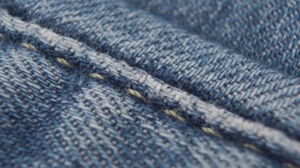 Naad Blauwe Jeans Met Oranje Draden Macro Dolly Schot — Stockvideo