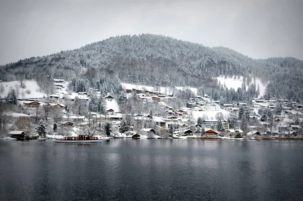 wintry landscape with snow-covered mountains at the tegernsee in bavaria