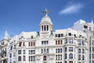 The iconic Edificio La Unin y el Fenix in Valencia, Spain, with its famous winged statue on the dome. A symbol of classic architecture and history in the city