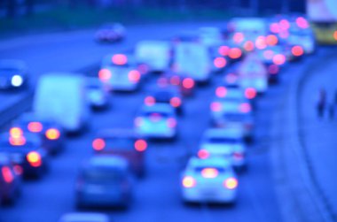 Akşamları kalabalık otoyolda hareket halindeki arabalarla şehir bulanıklaşır.