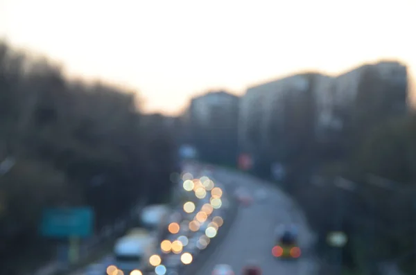 City in the evening with cars motion blurred light in busy highway