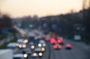 Akşamları kalabalık otoyolda hareket halindeki arabalarla şehir bulanıklaşır.