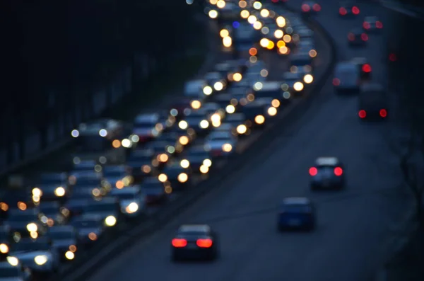 City in the evening with cars motion blurred light in busy highway