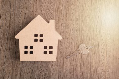 Ahşap ev medel ile sabah ışık ile ahşap tahta üzerinde anahtar