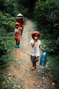 Si Phan Don / Laos - 06 Temmuz 2011: orman bahçe şirin çocukları ile geri gelen genç Aile