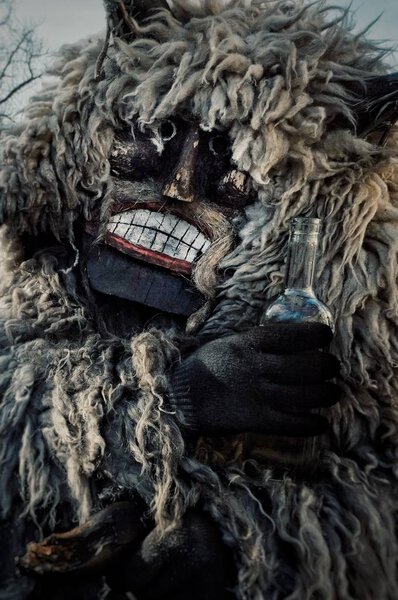 Mohacs, Baranya / Hungary - FEB 26 2017 : traditional participant called buso of the busojaras event holding a bottle of spirits as an important part of the celebration