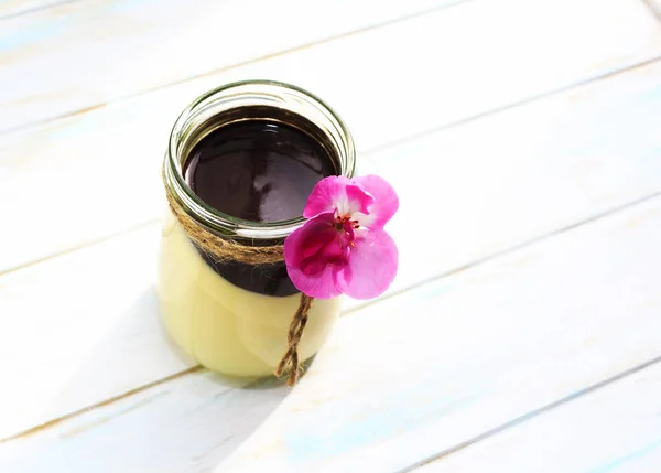 Vainilla panna cotta con salsa de chocolate, postre italiano, hecho en casa. Decorado con flor rosa — Foto de Stock