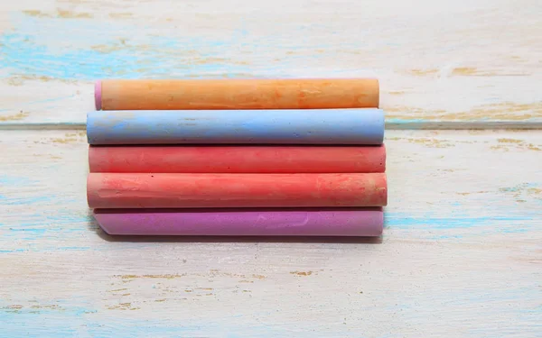 Colored chalk for drawing on a white wood background — Stock Photo, Image