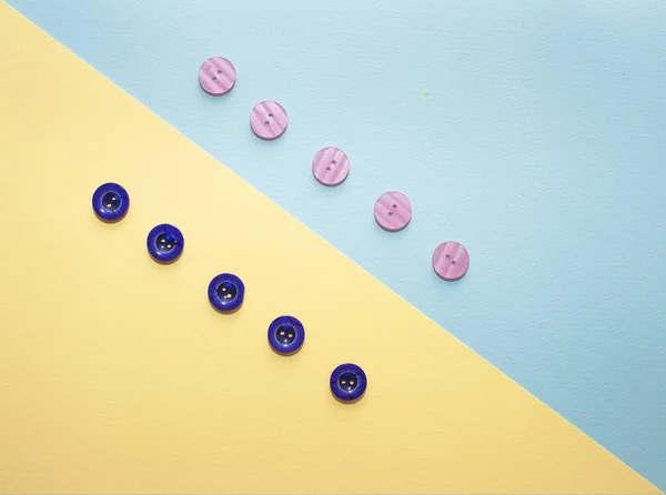 Collection of various multicolored sewing button on blue background. Yellow, purple, dark blue buttons. Minimalism. Sewing accessories. Flatlay, place for text — Stock Photo, Image