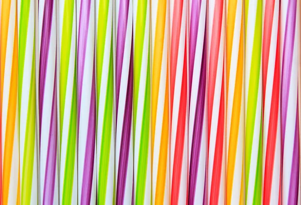 Abstract background of multi-colored striped cocktail straws