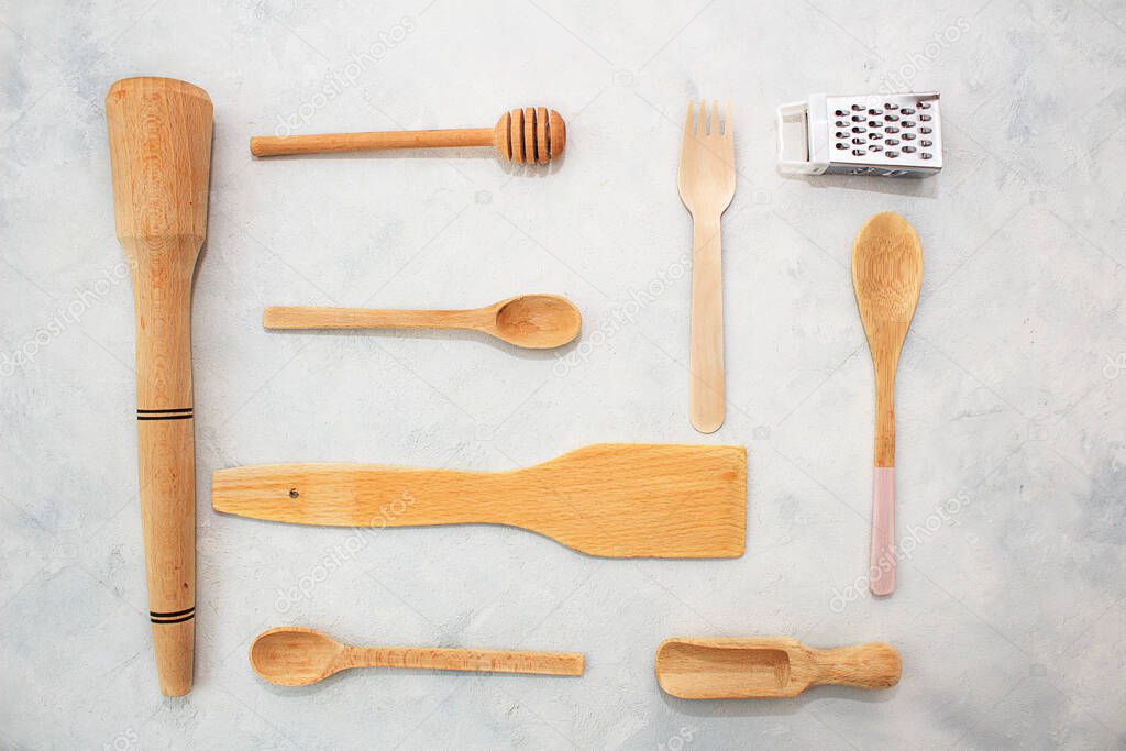 Kitchen wooden spoons for sugar, spices, honey on gray background wall