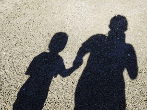 Shadow of father and daughter on the beach on the beach, Shadow of people.