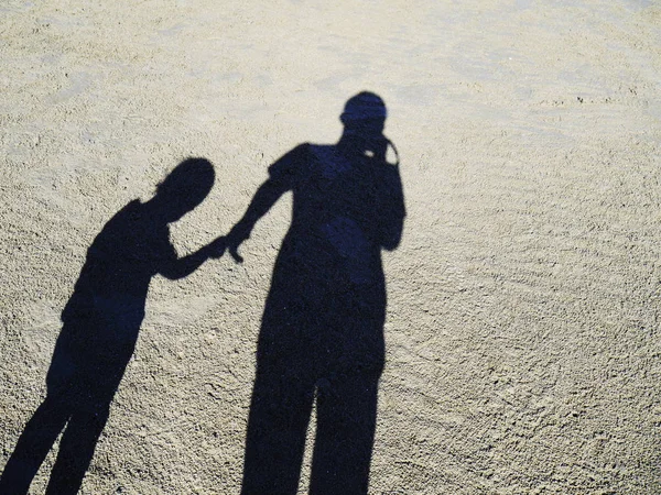 Shadow of father and daughter on the beach on the beach, Shadow of people.