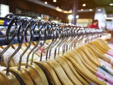 Seçici odak Ahşap elbise askısı modern dükkanı butikten rafta.