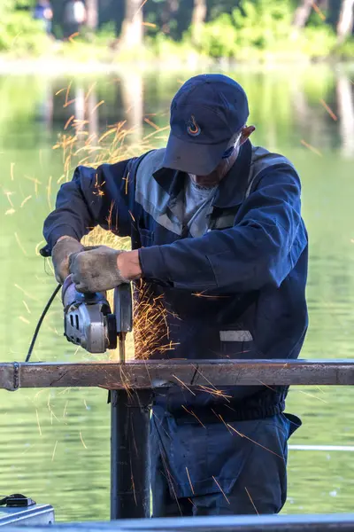 Balashikha, Moscow area, Rusya Federasyonu - 16 Haziran 2018: Şehir Park Pekhorka nehrinde set of inşaat metal tasarımları bölümlerini işçi keser