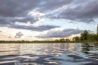 Bir göl ile akşam bulutlar üzerinde yaz günbatımı