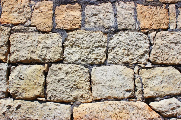 Stone wall surface on a sunny day