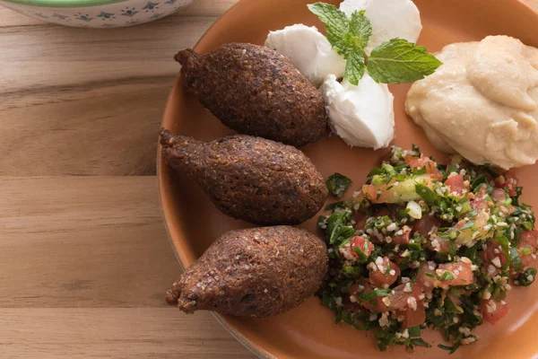 Healthy food. Middle Eastern food. Arabian food. Kibbeh (bulgur wheat/ meat ball), and Tabouleh