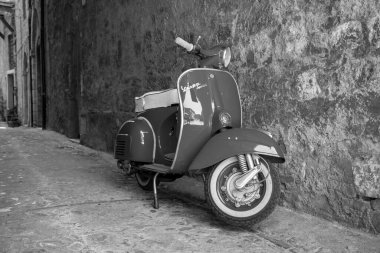 30 Haziran 2019 - Roma, Lazio, İtalya - Bir Piaggio Vespa Sprint, İtalya 'da antik bir köyün ara sokağında park halinde. İtalyan tasarımının scooter sembolü.