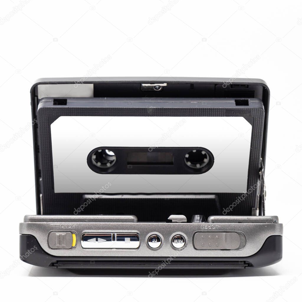 Vintage audio player. Old fashioned portable cassette player, cult object, icon and symbol of the 80s and 90s. Isolated on white background. Blank audio tape. Open door.