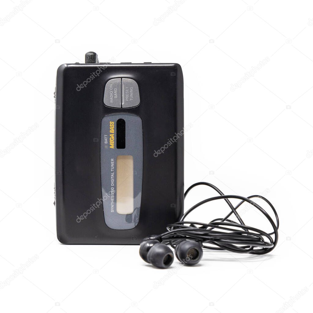 Vintage audio player. Old fashioned portable cassette player, cult object, icon and symbol of the 80s and 90s. Headphones isolated on white background.