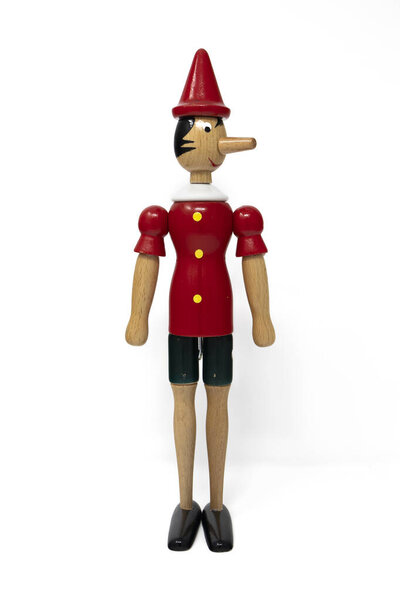 January 10, 2019 - Rome, Italy - Pinocchio, the wooden puppet, isolated on white background. From the Italian tale of Collodi. The nose grows when it says lies. Long nose. Traditional toy for children