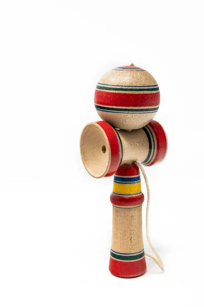 The original Kendama. An ancient, traditional, wooden Japanese skill toy for children. Has three cups and a spike which fits into the hole in the ball. Isolated on white background.