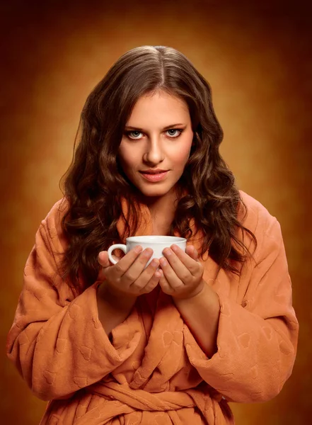 Coffee mug. Young woman holding coffee mug.
