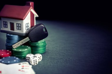 Poker masasında poker fişleri, kartları, plastik ev ve araba anahtarları
