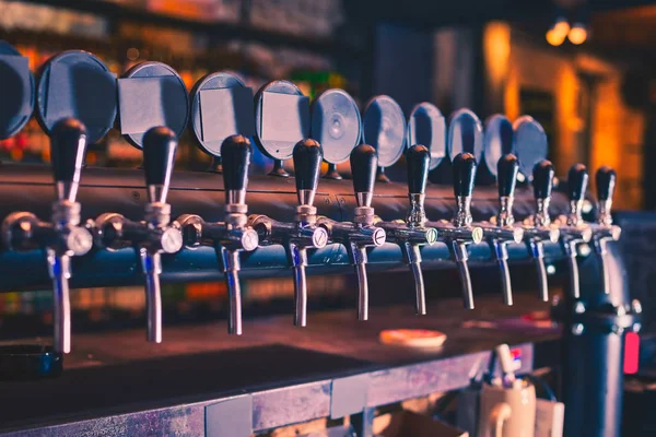 Beer taps in beer bar. Beer tap array.