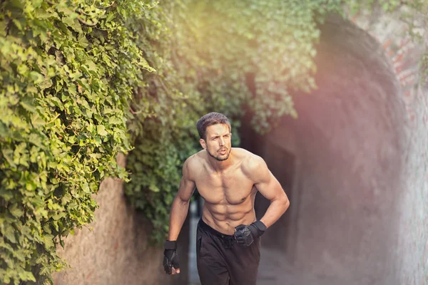 urban runner, sporty handsome shirtless man running, workout outdoor