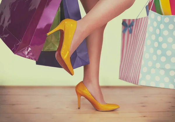 Woman in high heels with shopping bags, filtered image