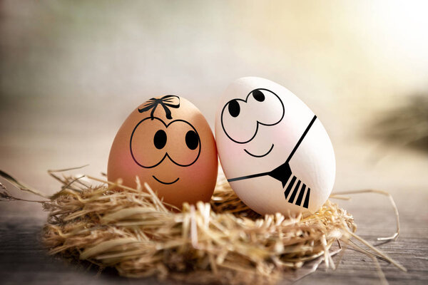 Two Easter eggs with drawing love face 