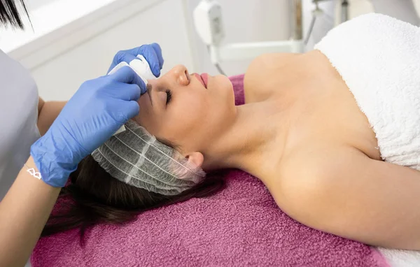 Primer plano de la mujer joven recibiendo tratamiento de spa en el salón de belleza . —  Fotos de Stock