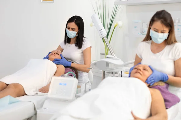 Mother and daughter together in cosmetic salon