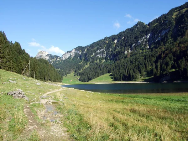 Alpine lake Seealpsee in mountain range Alpstein - Canton of Appenzell Innerrhoden, Switzerland