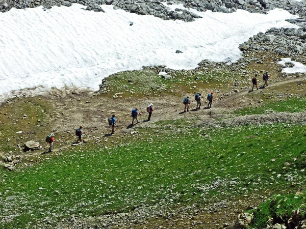 Mountain hikers on the Alpstein mountain range - Cantons of St. Gallen and Appenzell, Switzerland