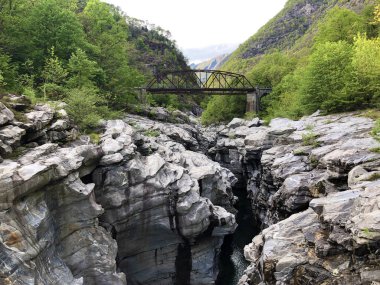 Granite rock formations in the Maggia river in the Maggia Valley or Valle Maggia, Tegna - Canton of Ticino, Switzerland clipart