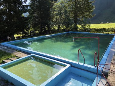 Bath and pool on the Sulzbach Alpine stream and in the Oberseetal valley, Nafels (Naefels) - Canton of Glarus, Switzerland clipart