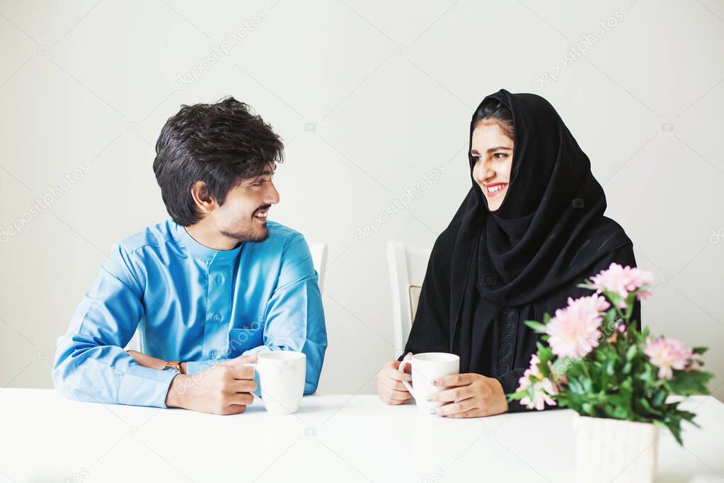 Nice beautiful Indian couple dressed in muslim arabic clothes ta