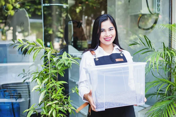 Happy Indonesian Woman Holding Container Roasted Coffee Beans Wearing Apron — Stock Photo, Image