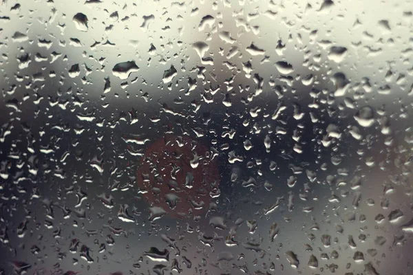 A drop of water on a gray glass — Stock Photo, Image