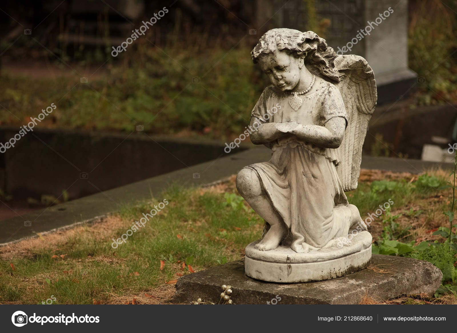 Statue Of A Weeping Angel In A Cemetery Stock Photo