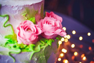 beyaz bir pasta üzerinde pembe güller