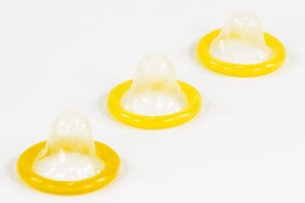 3 partially rolled-up condoms isolated on white background — Stock Image Partially Rolled Condoms Isolated White Background Stock Photo
