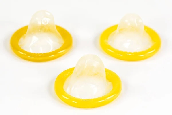 3 partially rolled-up condoms isolated on white background — Stock Image Partially Rolled Condoms Isolated White Background Royalty Free Stock Images