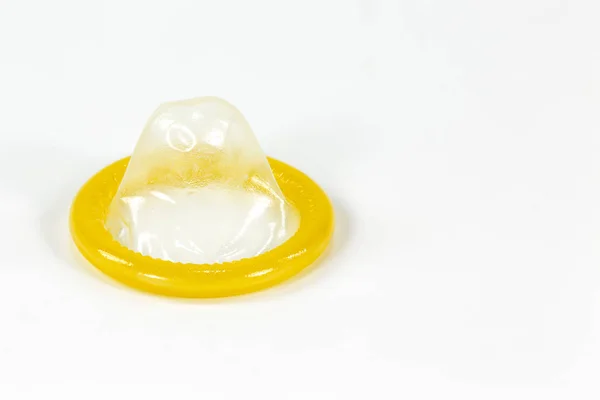A partially rolled-up condom on the left isolated on white background — Stock Image Partially Rolled Condom Left Isolated White Background Royalty Free Stock Images