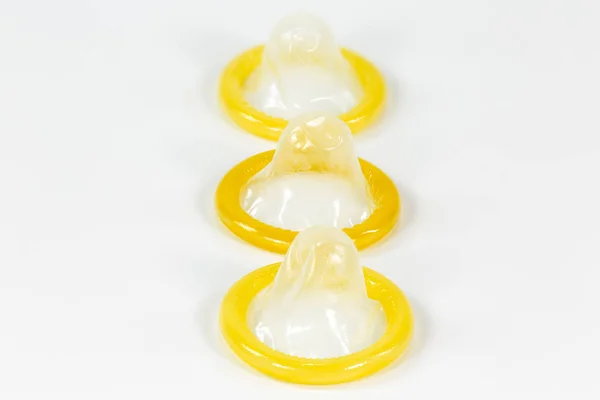 3 partially rolled-up condoms isolated on white background — Stock Image Partially Rolled Condoms Isolated White Background Stock Picture