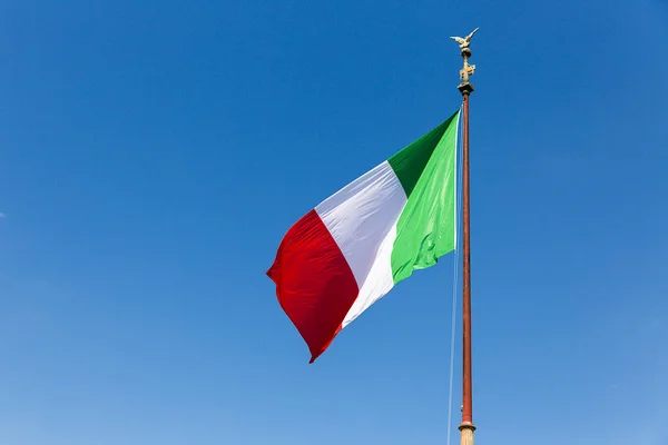 waving flag of the Republic of Italy against blue sky, Rome, Italy, Europe