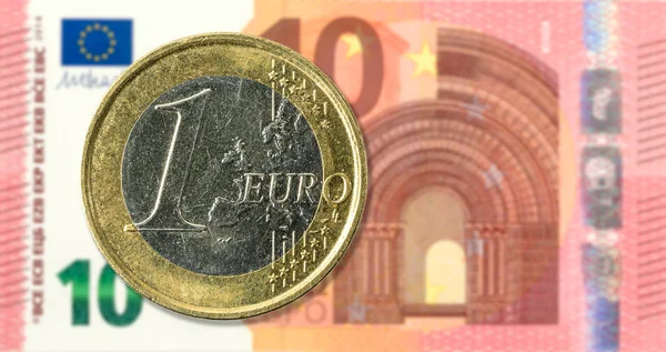 1 euro coins against 10 euro bank note full frame obverse